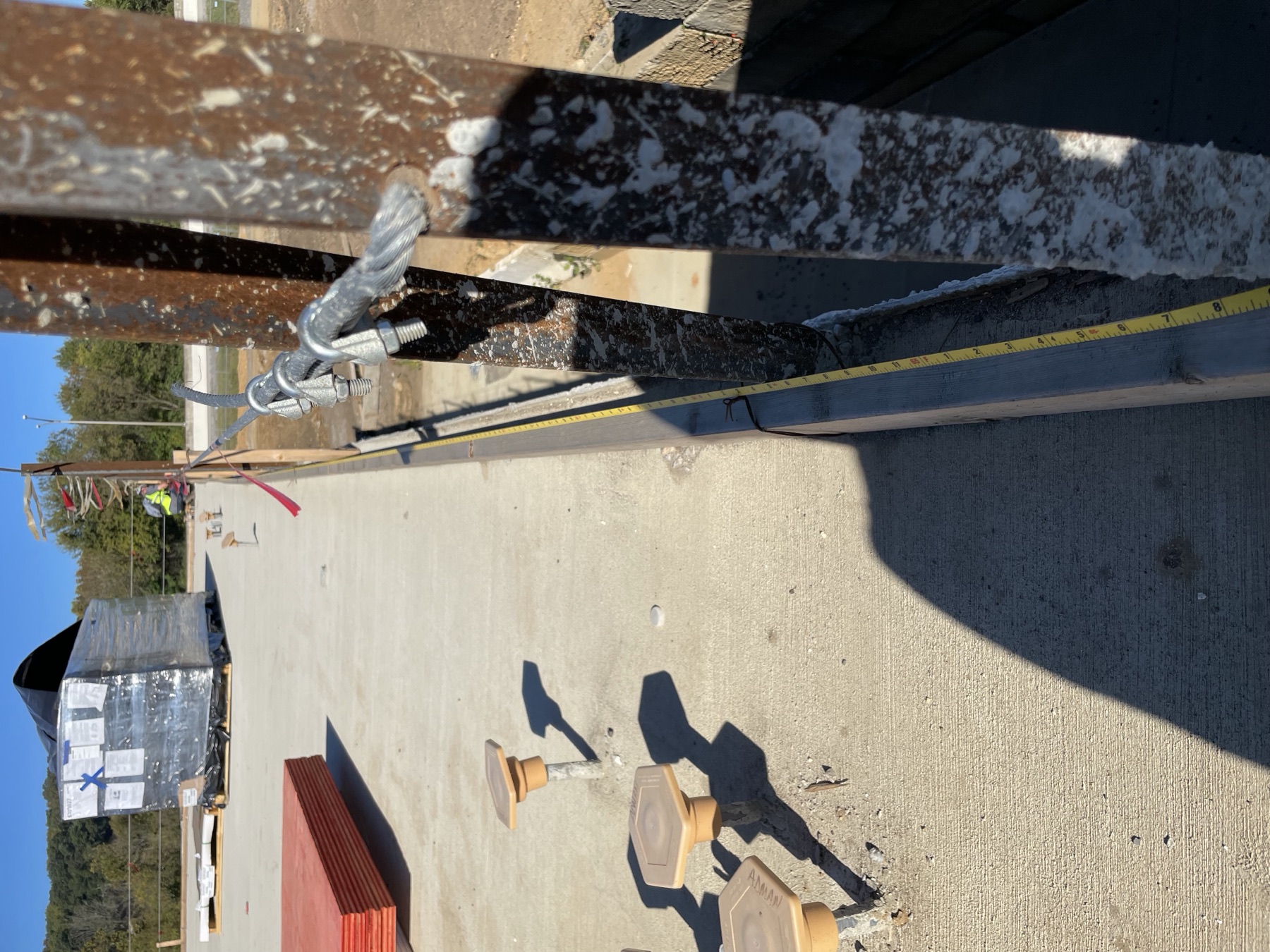 A long tape measurement running along an arena slab edge.